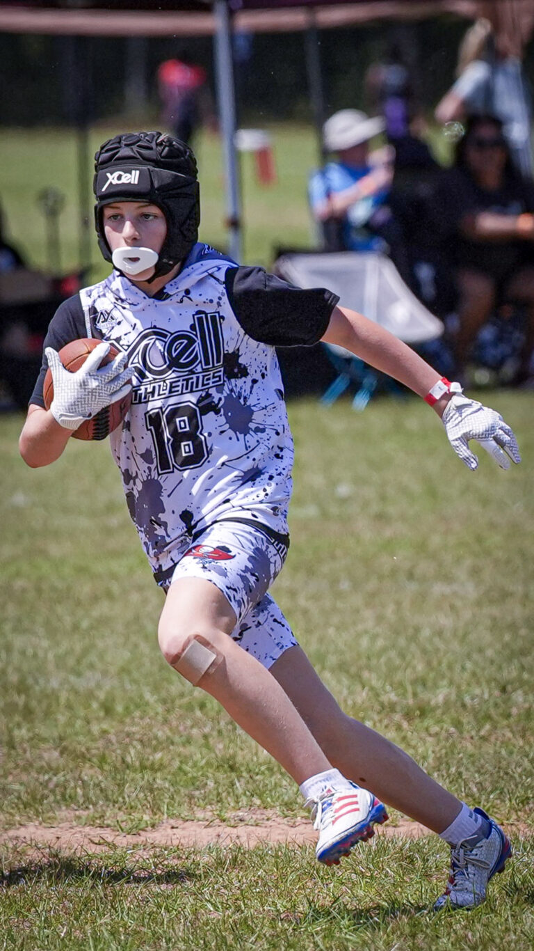 Lacrosse player cradling the ball on the run
