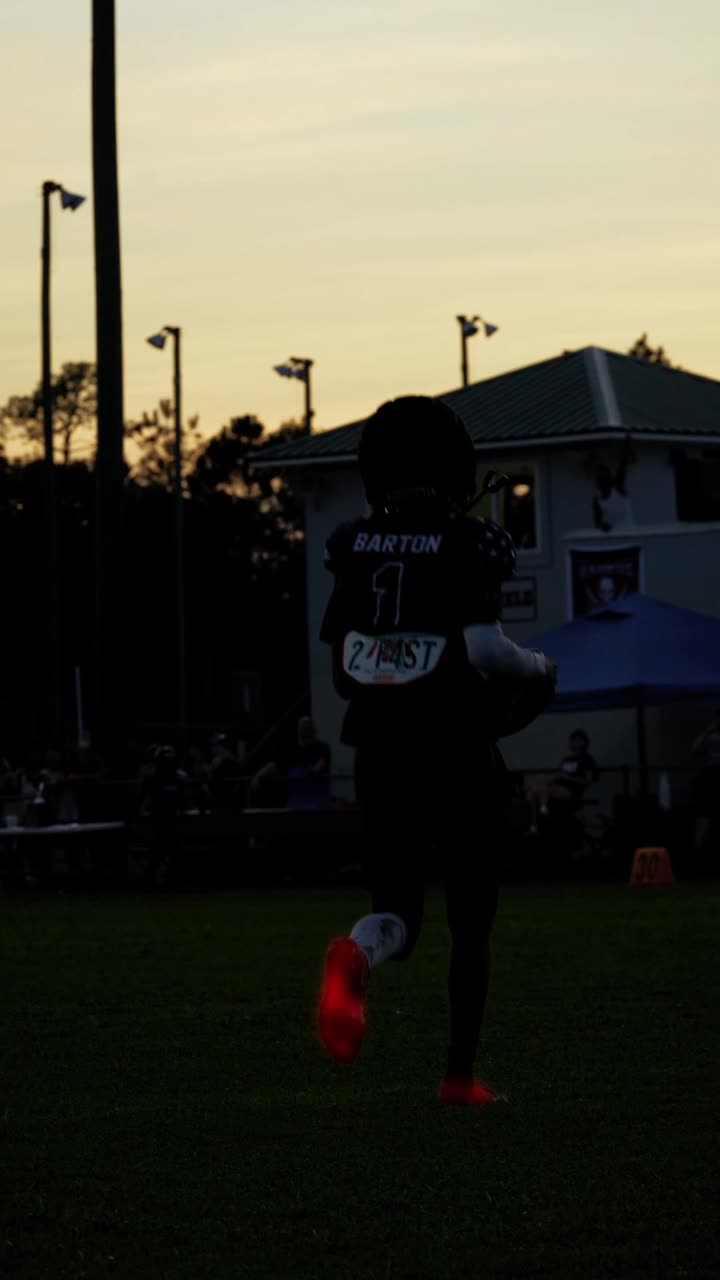 Ahmod Barton, number 1, jogging off at dusk with his 2 F4ST back plate